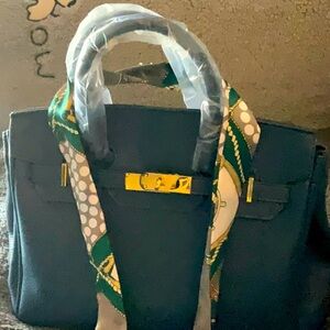 Pretty blue purse with gold hardware and a crossbody strap